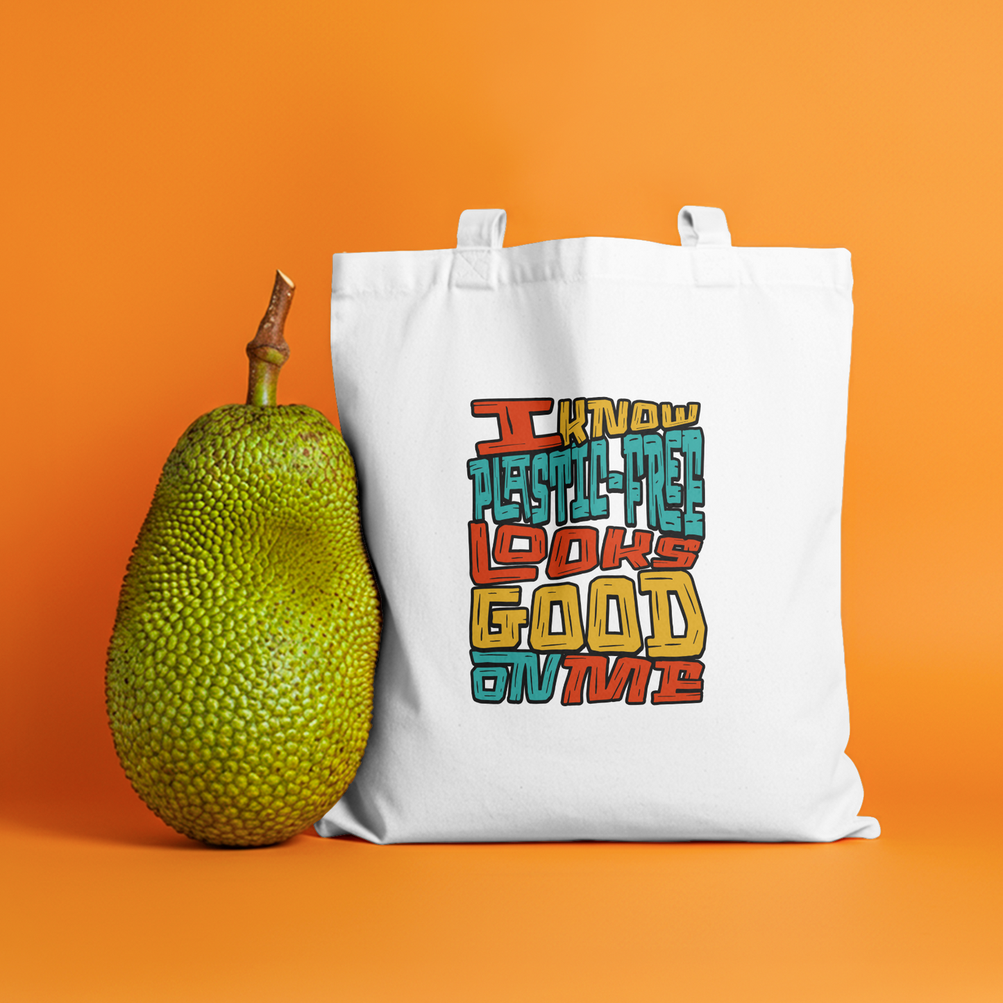 I Know Plastic-Free Looks Good on Me" eco-friendly canvas tote bag featuring a playful slogan and a nature-inspired design.