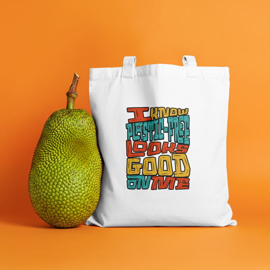 I Know Plastic-Free Looks Good on Me" eco-friendly canvas tote bag featuring a playful slogan and a nature-inspired design.
